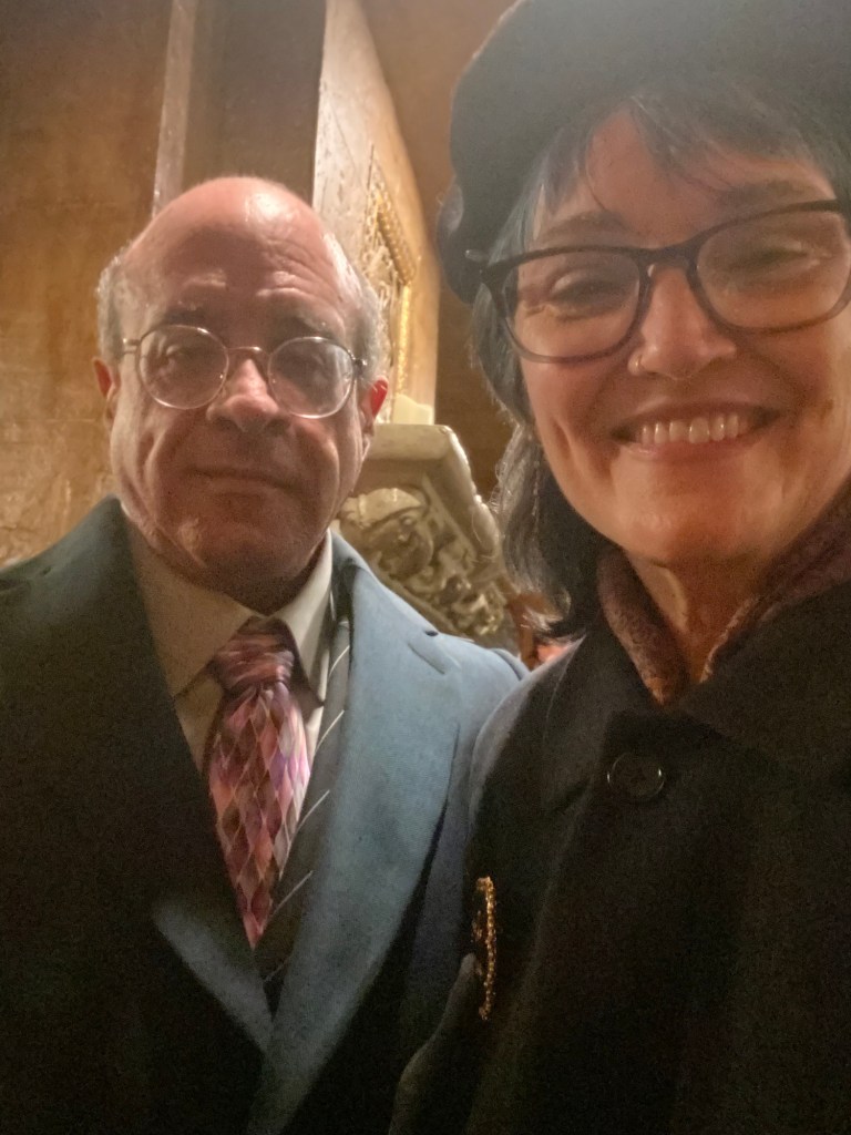 A handsome middle-aged couple in evening wear, looking happy but exhausted.